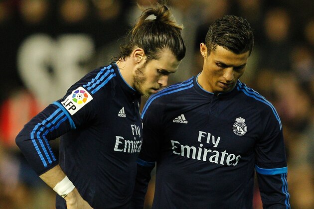 Real Madrid's Welsh forward Gareth Bale (L) and Real Madrid's Portuguese forward Cristiano Ronaldo look down during the Spanish league football match Valencia CF vs Real Madrid CF at the Mestalla stadium in Valencia on January 3, 2016.   AFP PHOTO/ JOSE JORDAN / AFP / JOSE JORDAN        (Photo credit should read JOSE JORDAN/AFP/Getty Images)
