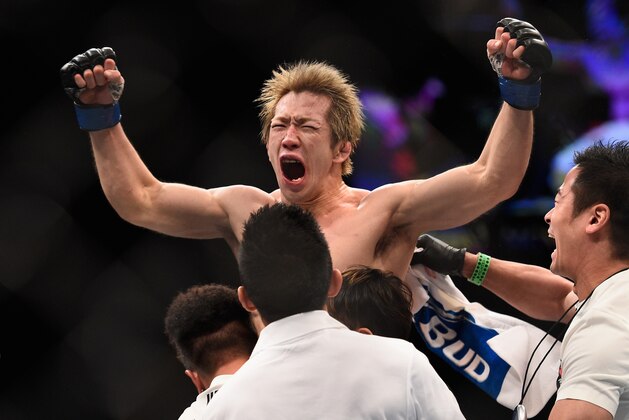 LAS VEGAS, NV - JANUARY 02:  Michinori Tanaka of Japan (top) reacts to his victory over Joe Soto in their bantamweight bout during the UFC 195 event inside MGM Grand Garden Arena on January 2, 2016 in Las Vegas, Nevada.  (Photo by Jeff Bottari/Zuffa LLC/Zuffa LLC via Getty Images)