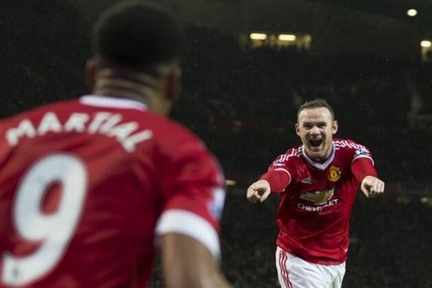 Manchester United's Wayne Rooney, right, celebrates with teammate Anthony Martial after scoring during the English Premier League soccer match between Manchester United and Swansea City at Old Trafford Stadium, Manchester, England, Saturday, Jan. 2, 2016. (AP Photo/Jon Super)