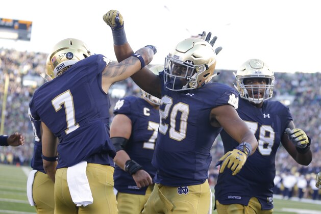 Notre Dame running back C.J. Prosise (20), right,  celebrates a touchdown wide receiver Will Fuller (7) during the second half of an NCAA college football game against Georgia Tech in South Bend, Ind., Saturday, Sept. 19, 2015. Notre Dame defeated Georgia Tech  30-22. (AP Photo/Michael Conroy)
