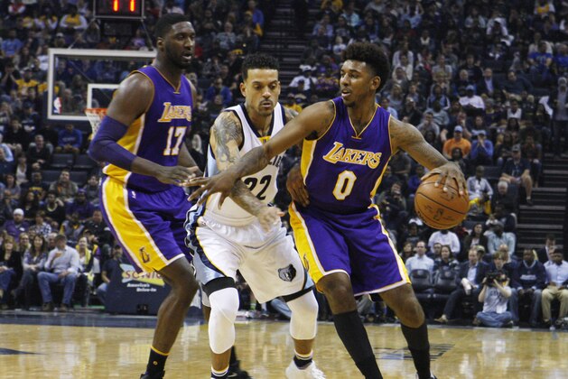 The Grizzlies Matt Barns, center, guards the Los Angeles Lakers Nick Young, right, in the first half of an NBA basketball game Sunday, Dec. 27, 2015, in Memphis, Tenn. At left is Lakers center Roy Hibbert. (AP Photo/Karen Pulfer Focht)