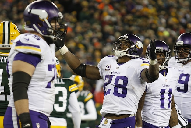 Minnesota Vikings' Adrian Peterson celebrates his touchdown run during the second half an NFL football game against the Green Bay Packers Sunday, Jan. 3, 2016, in Green Bay, Wis. (AP Photo/Matt Ludtke)