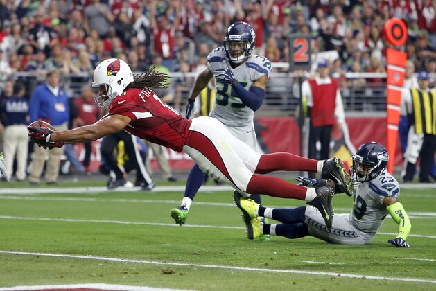 Arizona Cardinals wide receiver Larry Fitzgerald (11) scores a touchdown against the Seattle Seahawks during the first half of an NFL football game, Sunday, Jan. 3, 2016, in Glendale, Ariz. (AP Photo/Rick Scuteri)