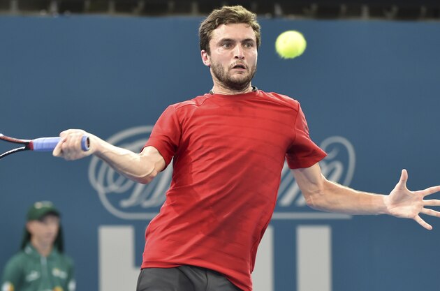 Giles Simon of France hits a return against Bulgaria's Grigor Dimitrov in their first round men's singles match at the Brisbane International tennis tournament on January 4, 2016.    AFP PHOTO / Saeed KHAN
-- IMAGE RESTRICTED TO EDITORIAL USE - STRICTLY NO COMMERCIAL USE / AFP / SAEED KHAN        (Photo credit should read SAEED KHAN/AFP/Getty Images)
