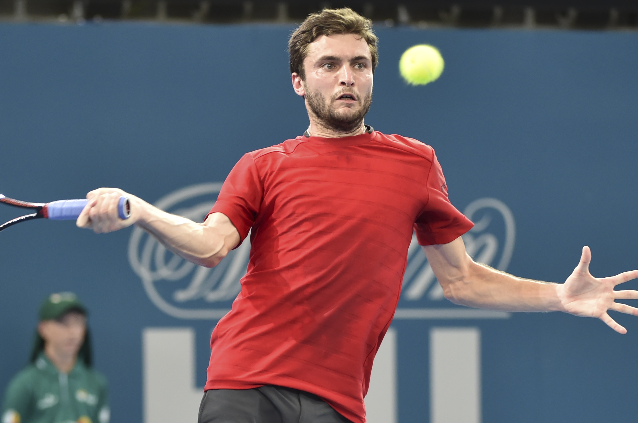 Giles Simon of France hits a return against Bulgaria's Grigor Dimitrov in their first round men's singles match at the Brisbane International tennis tournament on January 4, 2016.    AFP PHOTO / Saeed KHAN
-- IMAGE RESTRICTED TO EDITORIAL USE - STRICTLY NO COMMERCIAL USE / AFP / SAEED KHAN        (Photo credit should read SAEED KHAN/AFP/Getty Images)
