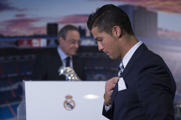 MADRID, SPAIN - OCTOBER 02:  Cristiano Ronaldo walks to the tribune ahead president Florentino Perez before receiving his trophy as all-time top scorer of Real Madrid CF at Honour box-seat of Santiago Bernabeu  Stadium on October 2, 2015 in Madrid, Spain. Portuguese palyer Cristiano Ronaldo overtook on his last UEFA Champions League match against Malmo FF Raul's record as Real Madrid all-time top scorer.  (Photo by Gonzalo Arroyo Moreno/Getty Images)