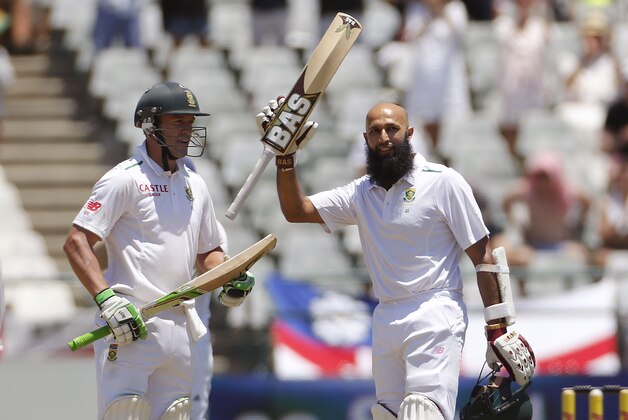 South African Hashim Amla, right, is congratulated by teammate  AB de Villiers, left, after making more then a hundred runs  during their second Test against England in Cape Town, South Africa,  Monday, Jan. 4, 2016.  (AP Photo/Schalk van Zuydam)