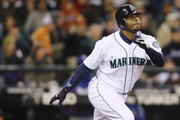 Seattle Mariners' Ken Griffey Jr. hits a solo home run on a pitch from Texas Rangers' Tommy Hunter during the fourth inning of a baseball game in Seattle on Saturday, Oct. 3, 2009. (AP Photo/John Froschauer)