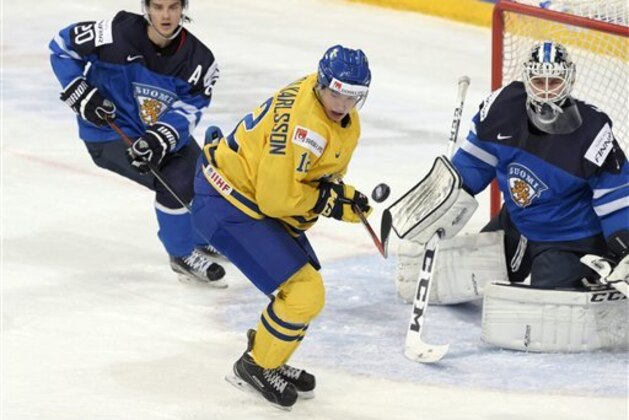 Finland's Sebastian Aho, left, and goalkeeper Kaapo Kahkonen, right, in action against Sweden's Jacob Forsbacka Karlsson during the 2016 IIHF World Junior Ice Hockey Championship semifinal match between Sweden and Finland in Helsinki, Monday, Jan. 4, 2016.  (Markuu Ulander/Lehtikuva via AP)       FINLAND OUT. NO THIRD PARTY SALES.