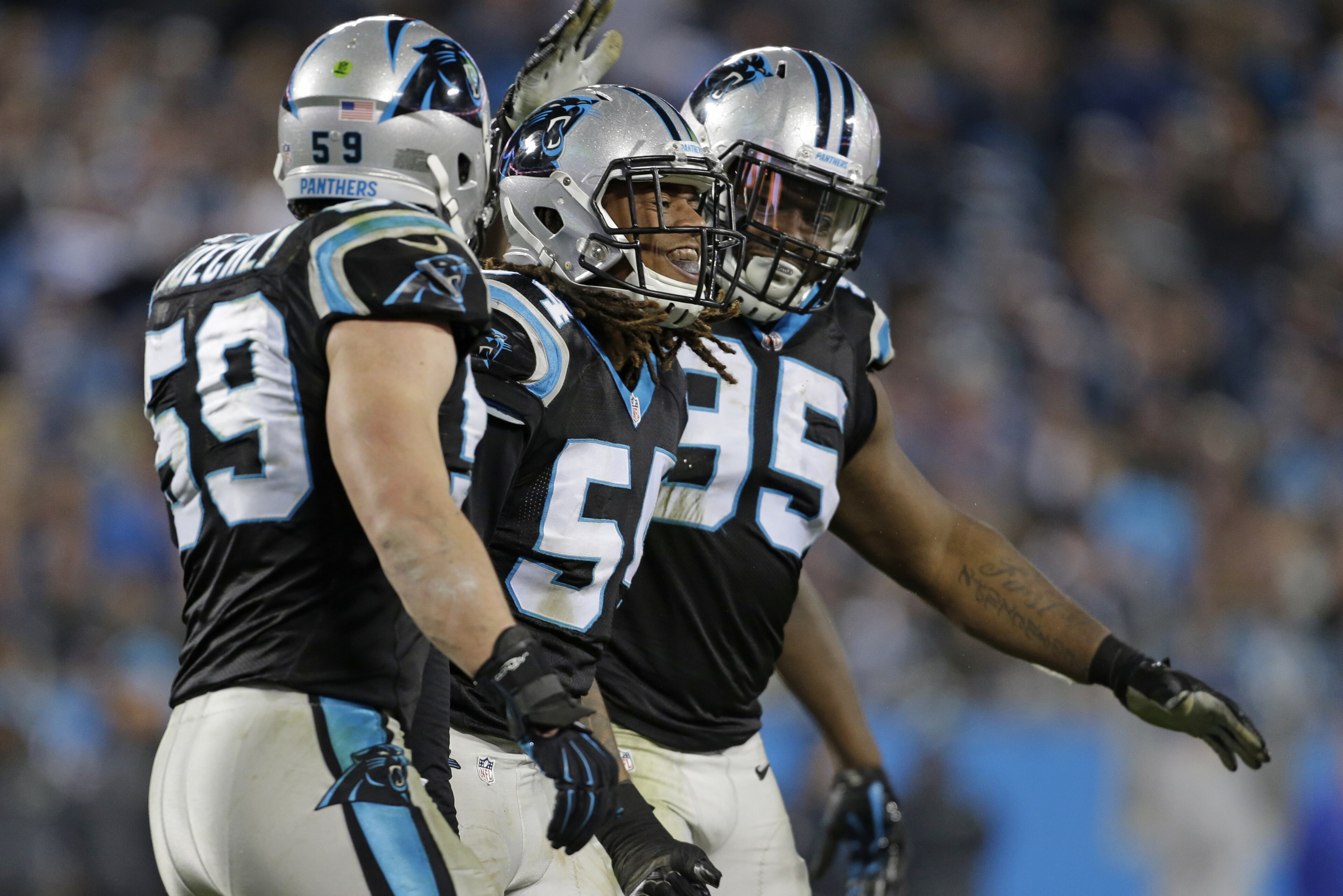 Carolina Panthers outside linebacker Shaq Green-Thompson, center, is congratulated by defensive end Charles Johnson (95) and middle linebacker Luke Kuechly (59) in the second half of an NFL football game against the Tampa Bay Buccaneers in Charlotte, N.C., Sunday, Jan. 3, 2016. (AP Photo/Bob Leverone)