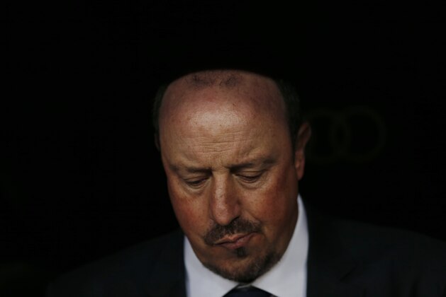 FILE - In this Nov. 21, 2015 file photo, Real Madrid's head coach Rafael Benitez sits on the bench before the first clasico of the season between Real Madrid and Barcelona at the Santiago Bernabeu stadium in Madrid, Spain. Real Madrid’s President Florentino Perez announced Monday Jan. 4, 2016 that current coach Rafael Benitez has been fired and former player and Real Madrid’s B team coach Zinedine Zidane will take over. Benitez, hired seven months ago, has been under pressure since a demoralising 4-0 home loss to Barcelona in November. The team won seven of nine matches since the defeat at the Bernabeu, but fans continued to call for Benitez's departure. (AP Photo/Daniel Ochoa de Olza, File)
