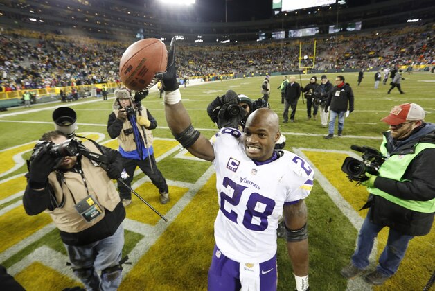 Minnesota Vikings' Adrian Peterson celebrates after an NFL football game against the Green Bay Packers Sunday, Jan. 3, 2016, in Green Bay, Wis. The Vikings won 20-13. (AP Photo/Mike Roemer)