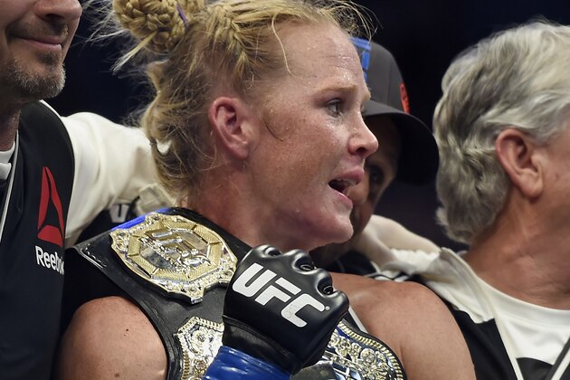 Holly Holm holds the champion belt after defeating Ronda Rousey during their UFC 193 bantamweight title fight in Melbourne, Australia, Sunday, Nov. 15, 2015. Holm pulled off a stunning upset victory over Rousey in the fight, knocking out the women's bantamweight champion in the second round with a powerful kick to the head Sunday. (AP Photo/Andy Brownbill)