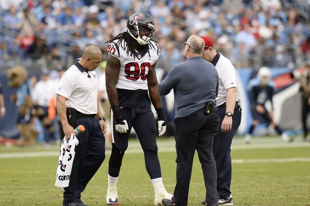 Houston Texans outside linebacker Jadeveon Clowney (90) is tended to after being injured in the second half of an NFL football game against the Tennessee Titans Sunday, Dec. 27, 2015, in Nashville, Tenn. The Texans won 34-6. (AP Photo/Mark Zaleski)