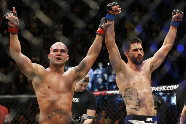 Robbie Lawler, left, and Carlos Condit celebrate after their welterweight championship mixed martial arts bout at UFC 195, Saturday, Jan. 2, 2016, in Las Vegas. Lawler won the bout. (AP Photo/John Locher)