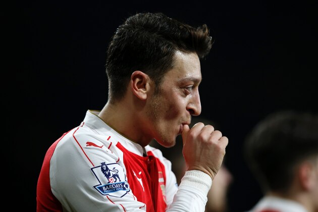 Arsenal's German midfielder Mesut Ozil celebrates after scoring their second goal during the English Premier League football match between Arsenal and Bournemouth at the Emirates Stadium in London on December 28, 2015. AFP PHOTO / ADRIAN DENNIS

RESTRICTED TO EDITORIAL USE. No use with unauthorized audio, video, data, fixture lists, club/league logos or 'live' services. Online in-match use limited to 75 images, no video emulation. No use in betting, games or single club/league/player publications. / AFP / ADRIAN DENNIS        (Photo credit should read ADRIAN DENNIS/AFP/Getty Images)