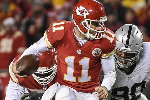 Kansas City Chiefs quarterback Alex Smith (11) scrambles away from Oakland Raiders defensive tackle Dan Williams (90) during the second half of their NFL football game in Kansas City, Mo., Sunday, Jan, 3, 2016. (AP Photo/Reed Hoffmann)