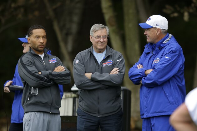 Buffalo Bills head coach Rex Ryan, right, talks with team owner Terry Pegula, center, and team manager Doug Whaley during an NFL training session at the Grove Hotel in Chandler's Cross, England, Thursday, Oct. 22, 2015. The Buffalo Bills play the Jacksonville Jaguars at Wembley stadium in London on Sunday in a regular season NFL game.  (AP Photo/Matt Dunham)