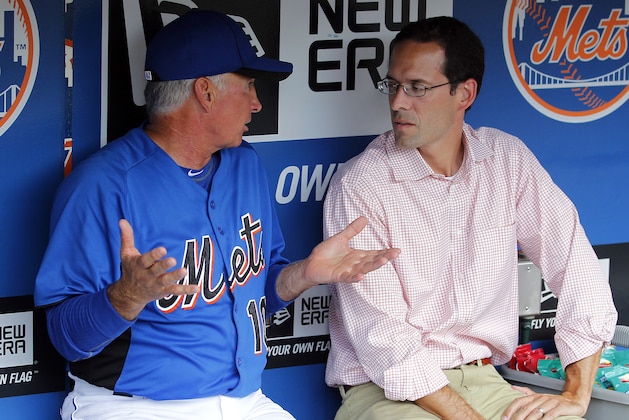 New York Mets manager Terry Collins talks with Mets VP of Player Development Paul DePodesta in the dugout before the game against the San Diego Padres in New York, Monday, Aug. 8, 2011. (AP Photo/Paul J. Bereswill)
