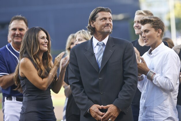 Former San Diego Padres pitcher Trevor Hoffman stands between his wife, Tracy, and one of his sons as he looks at a standing ovation by fans during his induction into the Padres' Hall-of-Fame Saturday, Aug. 30, 2014, in San Diego.  (AP Photo/Lenny Ignelzi)