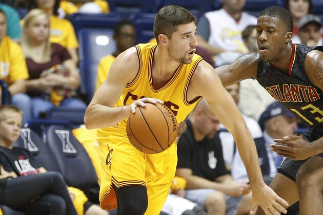 Cleveland Cavaliers guard Joe Harris, left, dribbles around Atlanta Hawks guard Lamar Patterson (13) in the second half of an NBA preseason basketball game, Wednesday, Oct. 7, 2015, in Cincinnati. The Hawks won 98-96. (AP Photo/John Minchillo)