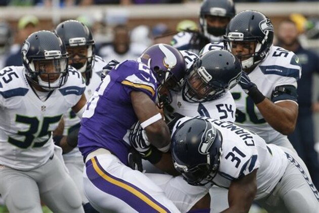 FILE - In this Dec. 6, 2015, file photo, Minnesota Vikings running back Adrian Peterson (28) is stopped by Seattle Seahawks defenders including  linebacker Bobby Wagner (54) and strong safety Kam Chancellor (31)in the first half of an NFL football game in Minneapolis. The Cardinals play the battered Minnesota Vikings on Thursday in Arizona. (AP Photo/Ann Heisenfelt, File)