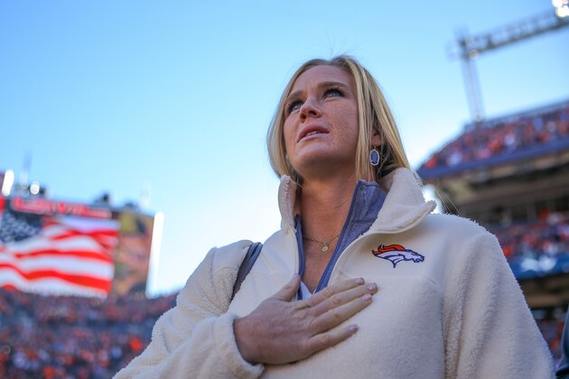 DENVER, CO - JANUARY 3:  Mixed martial artist Holly Holm, who competes in the Ultimate Fighting Championship bantamweight division, looks on during the singing of the national anthem before a game between the Denver Broncos and the San Diego Chargers at Sports Authority Field at Mile High on January 3, 2016 in Denver, Colorado. (Photo by Justin Edmonds/Getty Images)