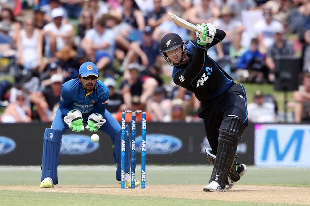 Martin Guptill (R) of New Zealand bats as Dinesh Chandimal of Sri Lanka looks on during the fifth one day international cricket match between New Zealand and Sri Lanka at the Bay Oval in Mount Maunganui on January 5, 2016. AFP PHOTO / MICHAEL BRADLEY / AFP / MICHAEL BRADLEY        (Photo credit should read MICHAEL BRADLEY/AFP/Getty Images)