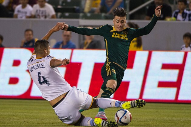 CARSON, CA - JUNE 24: Omar Gonzalez (4) of Los Angeles Galaxy slides in to take the ball from Jorge Villafana (19) of Portland Timbers during Los Angeles Galaxy's MLS match against Portland Timbers at the StubHub Center on June 24, 2015 in Carson, California.  The LA Galaxy won the match 5-0  (Photo: Shaun Clark/Getty Images)