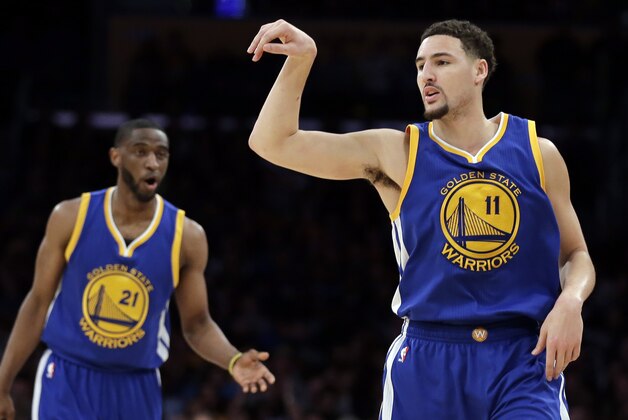 Golden State Warriors guard Klay Thompson, right, celebrates a basket as guard Ian Clark watches uring the first half of an NBA basketball game against the Los Angeles Lakers in Los Angeles, Tuesday, Jan. 5, 2016. (AP Photo/Chris Carlson)