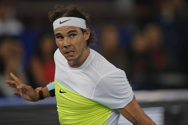 Rafael Nadal plays for Indian Aces against Edouard Roger Vasselin of Philippine Mavericks in the men's singles event of the International Premier Tennis League in New Delhi, India, Thursday, Dec. 10, 2015. (AP Photo/Tsering Topgyal)