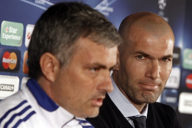 Special adviser to Real Madrid's first team Zinedine Zidane, right, looks on as Real Madrid's coach Jose Mourinho, left, talks during a press conference in Lyon, central France, Monday, Feb. 21, 2011. Real Madrid will face Lyon in a Champions League soccer match on Tuesday. (AP Photo/Laurent Cipriani)