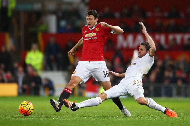 MANCHESTER, ENGLAND - JANUARY 02: Matteo Darmian of Manchester United and Angel Rangel of Swansea City compete for the ball during the Barclays Premier League match between Manchester United and Swansea City at Old Trafford on January 2, 2016 in Manchester, England.  (Photo by Alex Livesey/Getty Images)