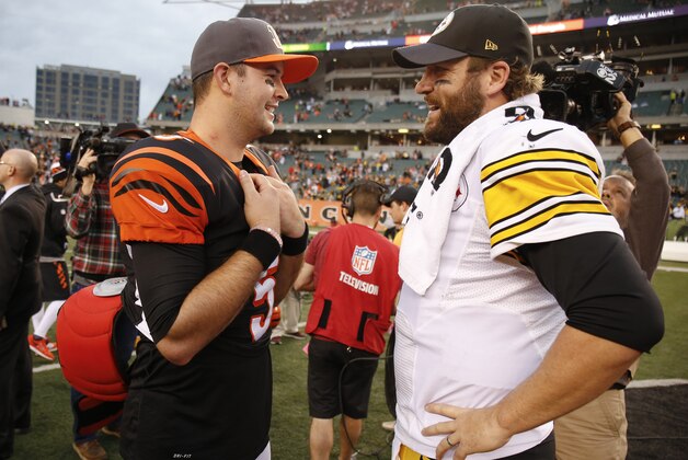 Cincinnati Bengals quarterback AJ McCarron, left, and Pittsburgh Steelers quarterback Ben Roethlisberger, right, meet on the field after an NFL football game, Sunday, Dec. 13, 2015, in Cincinnati. The Steelers won 33-20. (AP Photo/Gary Landers)