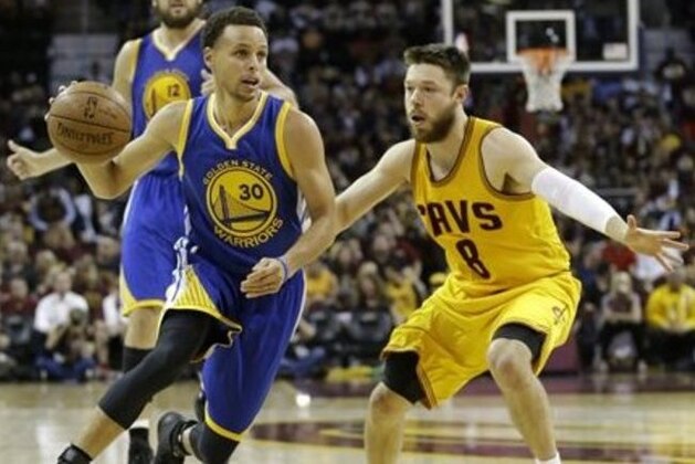 Golden State Warriors guard Stephen Curry (30) drives on Cleveland Cavaliers guard Matthew Dellavedova (8) during the second half of Game 3 of basketball's NBA Finals in Cleveland, Tuesday, June 9, 2015. (AP Photo/Tony Dejak)