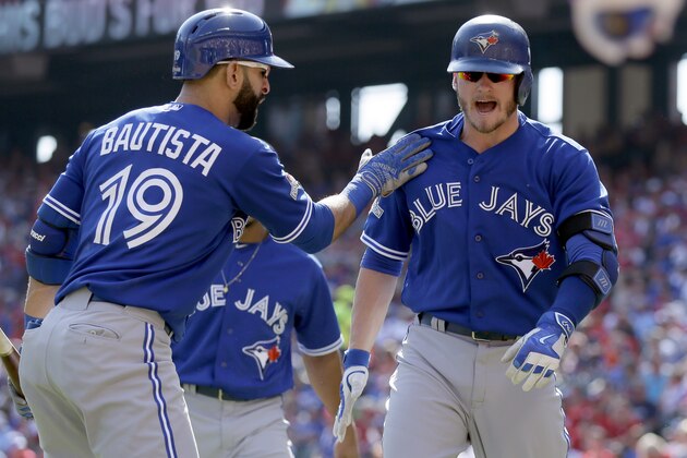 Toronto Blue Jays third baseman Josh Donaldson, right, celebrates his two-run home run with right fielder Jose Bautista (19) during the first inning in Game 4 of baseball's American League Division Series against the Texas Rangers, Monday, Oct. 12, 2015, in Arlington, Texas. (AP Photo/LM Otero)
