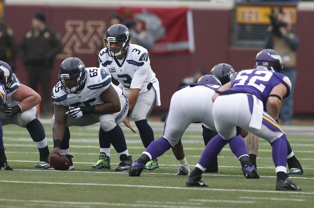 Seattle Seahawks quarterback Russell Wilson (3) calls signals at the line of scrimmage against the Minnesota Vikings in the first half of an NFL football game Sunday, Dec. 6, 2015 in Minneapolis. (AP Photo/Jim Mone)