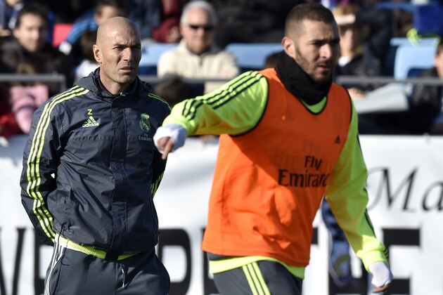 Real Madrid's new French coach Zinedine Zidane (L) looks at Real Madrid's French forward Karim Benzema during his first training session as coach of Real Madrid at the Alfredo di Stefano Stadium in Valdebebas, on the outskirts of Madrid, on January 5, 2016. Real Madrid legend Zinedine Zidane promised to put his 'heart and soul' into managing the Spanish giants after he was sensationally named as coach following Rafael Benitez's unceremonious sacking.   AFP PHOTO/ GERARD JULIEN / AFP / GERARD JULIEN        (Photo credit should read GERARD JULIEN/AFP/Getty Images)