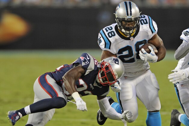 Carolina Panthers' Jonathan Stewart (28) runs as New England Patriots' Devin McCourty (32) defends during the first half of a preseason NFL football game in Charlotte, N.C., Friday, Aug. 28, 2015. (AP Photo/Mike McCarn)