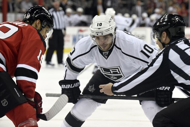 Los Angeles Kings' Mike Richards (10) prepares to take a face-off against New Jersey Devils' Travis Zajac during the first period of an NHL hockey game Monday, March 23, 2015, in Newark, N.J. (AP Photo/Bill Kostroun)