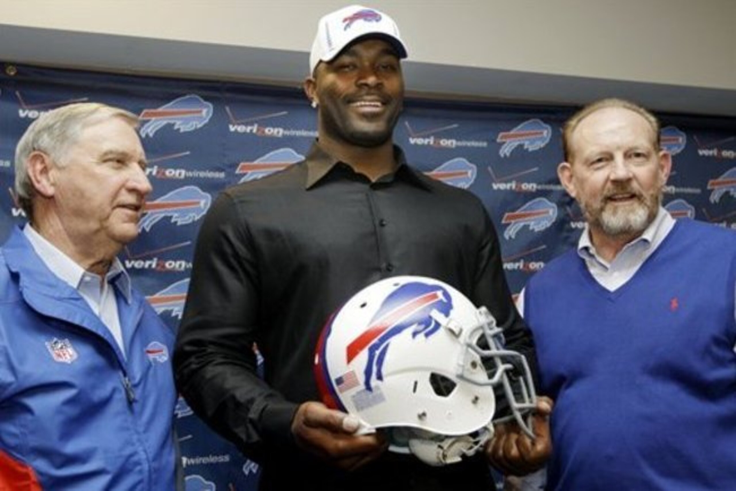 Buffalo Bills' Mario Williams, center, poses for a photo with Bills coach Chan Gailey, right, and Bills general manager Buddy Nix, left, after an NFL football news conference in Orchard Park, N.Y., Thursday, March 15, 2012. Williams signed a contract touted as the richest ever given to an NFL defensive player _ a deal worth up to $100 million with $50 million guaranteed, according to his agent, Ben Dogra. (AP Photo/David Duprey)