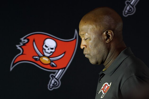 Tampa Bay Buccaneers head coach Lovie Smith walks off the stage after his end of the season news conference Monday, Jan. 4, 2016, in Tampa, Fla. The Buccaneers finished with a 6-10 record. (AP Photo/Chris O'Meara)