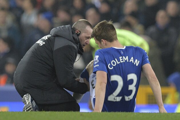 Everton's Irish defender Seamus Coleman (R) receives treatment before going off injured during the English League Cup semi-final first leg football match between Everton and Manchester City at Goodison Park in Liverpool, north west England on January 6, 2016. AFP PHOTO / PAUL ELLIS

RESTRICTED TO EDITORIAL USE. No use with unauthorized audio, video, data, fixture lists, club/league logos or 'live' services. Online in-match use limited to 75 images, no video emulation. No use in betting, games or single club/league/player publications. / AFP / PAUL ELLIS        (Photo credit should read PAUL ELLIS/AFP/Getty Images)