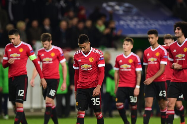 TOPSHOT - Manchester United's players look dejected as they leave the pitch after the UEFA Champions League Group B second-leg football match VfL Wolfsburg vs Manchester United in Wolfsburg, central Germany, on December 8, 2015.  / AFP / JOHN MACDOUGALL        (Photo credit should read JOHN MACDOUGALL/AFP/Getty Images)