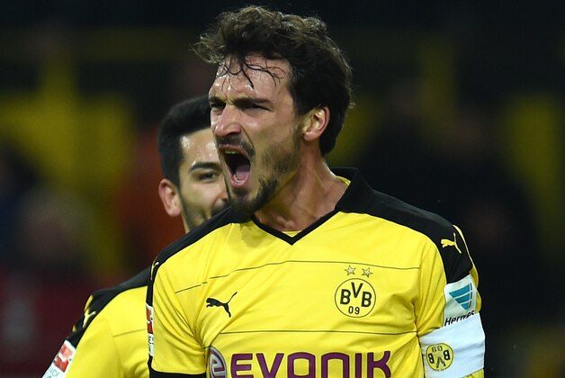 Dortmund's defender Mats Hummels celebrates during the German first division Bundesliga football match Borussia Dortmund vs Eintracht Frankfurt in Dortmund, western Germany, on December 13, 2015. Dortmund won the match 4 - 1. 
AFP PHOTO / PATRIK STOLLARZ

RESTRICTIONS: DURING MATCH TIME: DFL RULES TO LIMIT THE ONLINE USAGE TO 15 PICTURES PER MATCH AND FORBID IMAGE SEQUENCES TO SIMULATE VIDEO. == RESTRICTED TO EDITORIAL USE == FOR FURTHER QUERIES PLEASE CONTACT DFL DIRECTLY AT + 49 69 650050. / AFP / PATRIK STOLLARZ        (Photo credit should read PATRIK STOLLARZ/AFP/Getty Images)