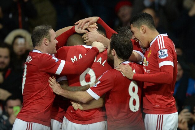 Manchester United's French striker Anthony Martial (C) is congratulated by teammates during the English Premier League football match between Manchester United and Swansea City at Old Trafford in Manchester, north west England, on January 2, 2016. AFP PHOTO / OLI SCARFF

RESTRICTED TO EDITORIAL USE. No use with unauthorized audio, video, data, fixture lists, club/league logos or 'live' services. Online in-match use limited to 75 images, no video emulation. No use in betting, games or single club/league/player publications. / AFP / OLI SCARFF        (Photo credit should read OLI SCARFF/AFP/Getty Images)