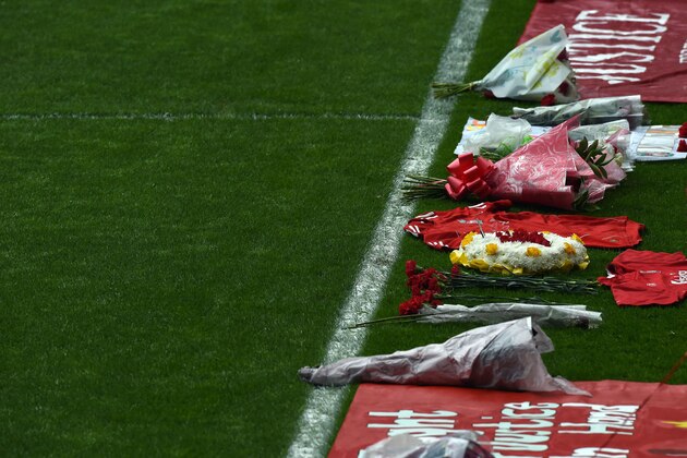 Flowers lie on the side of the pitch during a memorial service at Anfield in Liverpool, north west Engand on April 15, 2015, on the 26th anniversary of the Hillsborough Disaster, where 96 Liverpool supporters died at the 1989 FA Cup semi final between Liverpool and Nottingham Forest at Hillsborough football ground in Sheffield. AFP PHOTO / PAUL ELLIS        (Photo credit should read PAUL ELLIS/AFP/Getty Images)