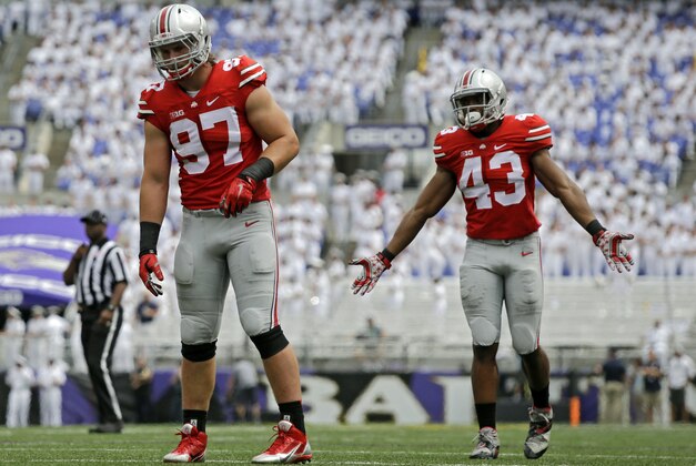 FILE - In this Aug. 30, 2014, file photo, Ohio State defensive lineman Joey Bosa, left, and linebacker Darron Lee play in the first half of an NCAA college football game against Navy in Baltimore. Bosa, Lee and the rest of the Ohio State defense will have their hands full with quarterback Gunner Kiel and pass-happy Cincinnati coming to town Saturday. (AP Photo/Patrick Semansky, File)