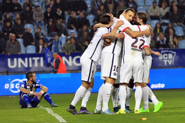Paris Saint-Germain's Swedish forward Zlatan Ibrahimovic (C) celebrates with teammates after scoring a goal during the L1 football match Bastia (SCB) against Paris (PSG) on October 17, 2015, at the Armand Cesari stadium in Bastia, on the French Mediterranean island of Corsica. AFP PHOTO / PASCAL POCHARD-CASABIANCA        (Photo credit should read PASCAL POCHARD CASABIANCA/AFP/Getty Images)