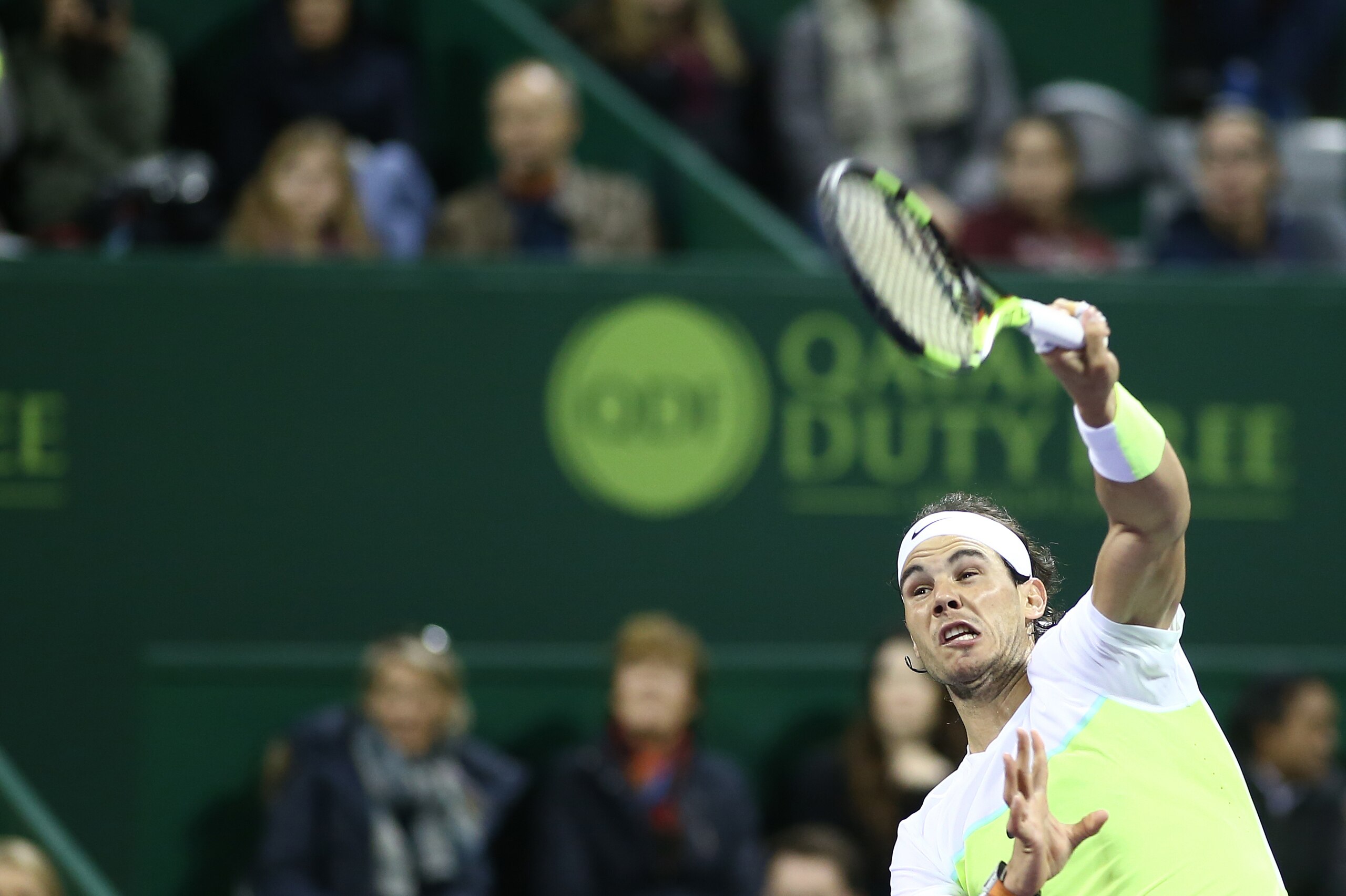 Rafael Nadal of Spain serves to Robin Haase of Netherlands during their tennis match in the Qatar Open tournament on January 6, 2016, in Doha. Nadal won 6-3, 6-2.  AFP PHOTO / KARIM JAAFAR / AFP / KARIM JAAFAR        (Photo credit should read KARIM JAAFAR/AFP/Getty Images)